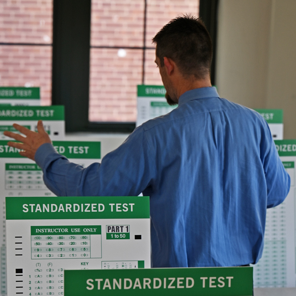 Conceptual image of teacher teaching to a bunch of tests