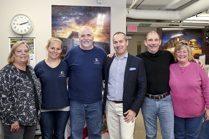 Printing and Mailing Services staff pose with President Katherine Bergeron