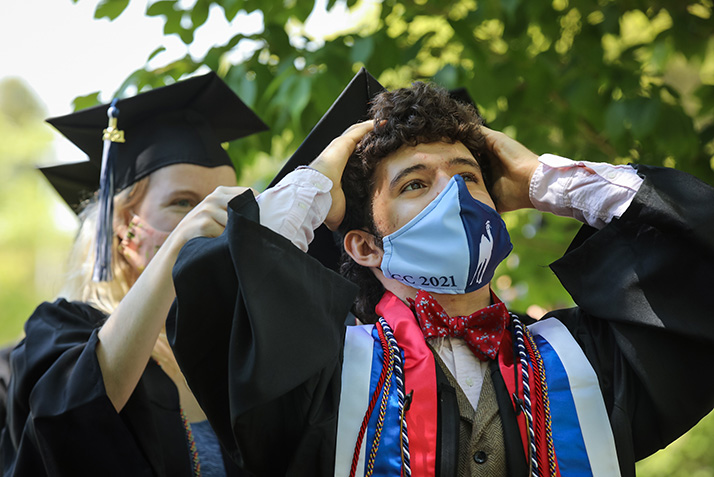 A graduate waits to walk across the stage. 