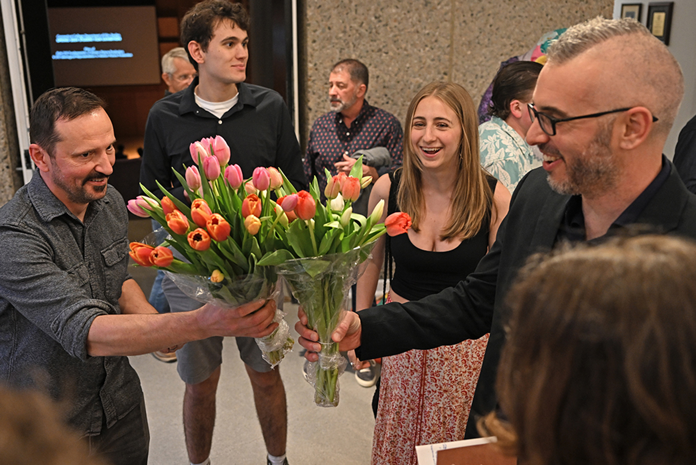 Students present their professors with bouquets of flowers