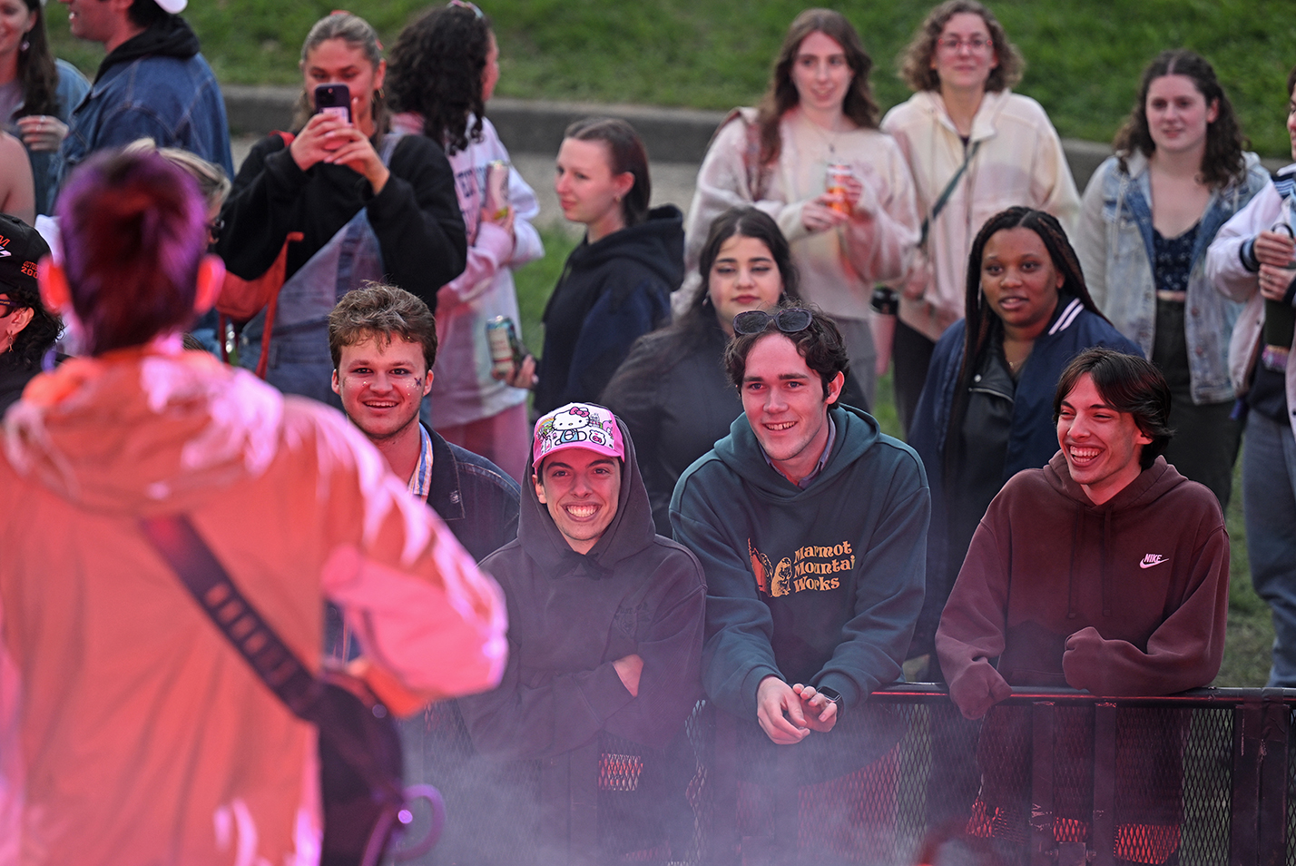 Students in a concert audience watch a band perform onstage